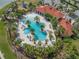 Stunning aerial view of the community pool, showcasing its unique design, surrounding greenery, and resort-style amenities at 5821 Hevena Ct, Palmetto, FL 34221