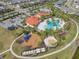 Wonderful aerial view showcasing the community pool, playground, splash pad, landscaping, and amenities, all within the neighborhood at 5821 Hevena Ct, Palmetto, FL 34221