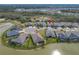 A neighborhood with well-maintained lawns surrounds a serene pond, showcasing community living at 5821 Hevena Ct, Palmetto, FL 34221