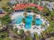 Expansive aerial view of the community pool with palm trees and cabanas, perfect for relaxing and enjoying the Florida sunshine at 5821 Hevena Ct, Palmetto, FL 34221