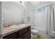 The bathroom features a vanity with a granite countertop and a tub/shower with a white shower curtain at 5821 Hevena Ct, Palmetto, FL 34221