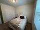 A cozy bedroom with a window that lets in natural light and a closet for storage at 5821 Hevena Ct, Palmetto, FL 34221