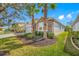A house with a well-maintained lawn with mature landscaping and lots of curb appeal at 5821 Hevena Ct, Palmetto, FL 34221
