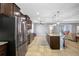 Spacious kitchen with stainless steel appliances, dark cabinetry, granite countertops, and large central island at 5821 Hevena Ct, Palmetto, FL 34221