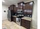 Kitchen featuring stainless appliances and dark cabinets with a black backsplash and granite countertops at 5821 Hevena Ct, Palmetto, FL 34221