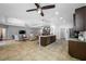 Open kitchen with stainless steel appliances, dark cabinets and a spacious island that flows into the living area at 5821 Hevena Ct, Palmetto, FL 34221