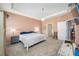 Bright, carpeted main bedroom with a tray ceiling, natural light, and neutral tones at 5821 Hevena Ct, Palmetto, FL 34221