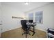 This office space is furnished with a desk and large monitors and has lots of natural light at 5821 Hevena Ct, Palmetto, FL 34221