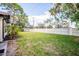 Large fenced backyard with healthy green grass and mature trees at 6205 Green View Dr # 129, Sarasota, FL 34231