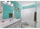 Bright bathroom features a white vanity, toilet, shower and light blue walls at 6205 Green View Dr # 129, Sarasota, FL 34231
