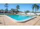 Community pool surrounded by deck, lounge chairs, and manicured landscaping at 6205 Green View Dr # 129, Sarasota, FL 34231