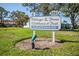 Community sign indicating 'Village of the Pines Clubhouse & Pool' at 6205 Green View Dr # 129, Sarasota, FL 34231