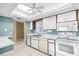 Bright kitchen featuring white appliances, ample cabinet space, and tiled floors at 6205 Green View Dr # 129, Sarasota, FL 34231