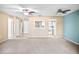 Open-concept carpeted living room, with dining area and view into the kitchen at 6205 Green View Dr # 129, Sarasota, FL 34231