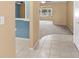Open layout living room with tiled flooring near kitchen and carpeted spacious area at 6205 Green View Dr # 129, Sarasota, FL 34231