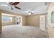 Large carpeted living space with ceiling fans and sliding door access to outdoor area at 6205 Green View Dr # 129, Sarasota, FL 34231