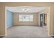 Spacious carpeted living space with large window for natural light and sliding door to screened in porch at 6205 Green View Dr # 129, Sarasota, FL 34231