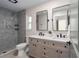 Beautiful bathroom features a double vanity sink, black fixtures, and a tiled walk-in shower with marble accent wall at 6705 20Th W Ave, Bradenton, FL 34209