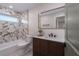 Bathroom featuring decorative tiling, dark wood vanity and modern fixtures at 6705 20Th W Ave, Bradenton, FL 34209