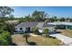 Charming single-story home with a well-maintained lawn and tropical landscaping at 6705 20Th W Ave, Bradenton, FL 34209