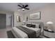 Cozy main bedroom with contemporary decor, a ceiling fan, and an ensuite door to a walk-in closet at 6705 20Th W Ave, Bradenton, FL 34209