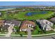 Aerial view of an expansive home on a landscaped lot with views of neighborhood ponds at 712 Crosswind Ave, Sarasota, FL 34240