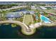 Aerial view of Lakehouse Cove amenities with pools, clubhouse, beach area, and lake access at 712 Crosswind Ave, Sarasota, FL 34240