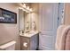 Bathroom featuring a modern vanity with white countertop, stylish lighting, and framed art at 7760 Grande Shores Dr, Sarasota, FL 34240