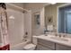 Bathroom showcasing a combined shower and tub, complete with a modern vanity and neutral decor at 7760 Grande Shores Dr, Sarasota, FL 34240