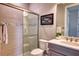 Bathroom boasts tiled shower with glass doors and a modern vanity with light countertop at 7760 Grande Shores Dr, Sarasota, FL 34240