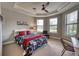 Bright bedroom with a fan, light-colored walls, and multiple windows at 7760 Grande Shores Dr, Sarasota, FL 34240