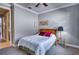 Bedroom with a queen bed, gray walls, white trim and a ceiling fan at 7760 Grande Shores Dr, Sarasota, FL 34240