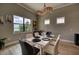 Dining area featuring a white table and modern chairs, with a view of the landscape and waterfront at 7760 Grande Shores Dr, Sarasota, FL 34240