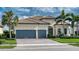 Beautiful single-story home with a tile roof, a paver driveway, and a two-car garage at 7760 Grande Shores Dr, Sarasota, FL 34240