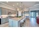 Spacious kitchen with gray cabinets, granite countertops, stainless steel appliances, and a large island at 7760 Grande Shores Dr, Sarasota, FL 34240