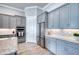 Bright kitchen featuring gray cabinets, stainless steel appliances, and granite countertops at 7760 Grande Shores Dr, Sarasota, FL 34240