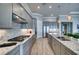 Modern kitchen with gray cabinets, stainless steel appliances, and a mosaic backsplash at 7760 Grande Shores Dr, Sarasota, FL 34240