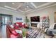 Spacious living room with tray ceiling, modern fireplace and black and white rug at 7760 Grande Shores Dr, Sarasota, FL 34240