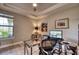 Office with a glass top desk, modern chair and a large window allowing natural light at 7760 Grande Shores Dr, Sarasota, FL 34240