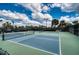 Outdoor tennis courts with green and blue surfaces for recreational play at 7760 Grande Shores Dr, Sarasota, FL 34240