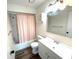 Cozy bathroom featuring a vanity, mirror, and a shower with a pink curtain at 1022 De Soto Dr, Dunedin, FL 34698