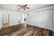 Bright bedroom with wood floors, ceiling fan, and access to closet and other rooms at 1022 De Soto Dr, Dunedin, FL 34698