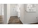 Bright entryway showcasing updated wood flooring and a clear view into the kitchen at 1022 De Soto Dr, Dunedin, FL 34698