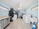 Bright laundry room with multiple machines, a utility sink, and a folding table for convenience at 1022 De Soto Dr, Dunedin, FL 34698