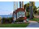 Scenic welcome sign to Dunedin with waterfront views, palm trees, and lush landscaping at 1022 De Soto Dr, Dunedin, FL 34698