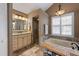 Lovely bathroom featuring a large soaking tub, walk-in shower, and an elegant lighting fixture at 1209 89Th Nw St, Bradenton, FL 34209