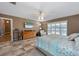 A comfortably appointed main bedroom features a light ceiling fan and a large window at 1209 89Th Nw St, Bradenton, FL 34209