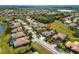 Aerial view of a neighborhood showcasing the home's location and the surrounding community, golf course, and lake at 12810 Daisy Pl, Bradenton, FL 34212
