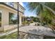 Backyard area with a patio, landscaping, and a view of the house's large window and pool at 12810 Daisy Pl, Bradenton, FL 34212