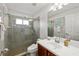 Clean and bright bathroom featuring a glass-enclosed shower, and a sleek vanity with decorative accents at 12810 Daisy Pl, Bradenton, FL 34212